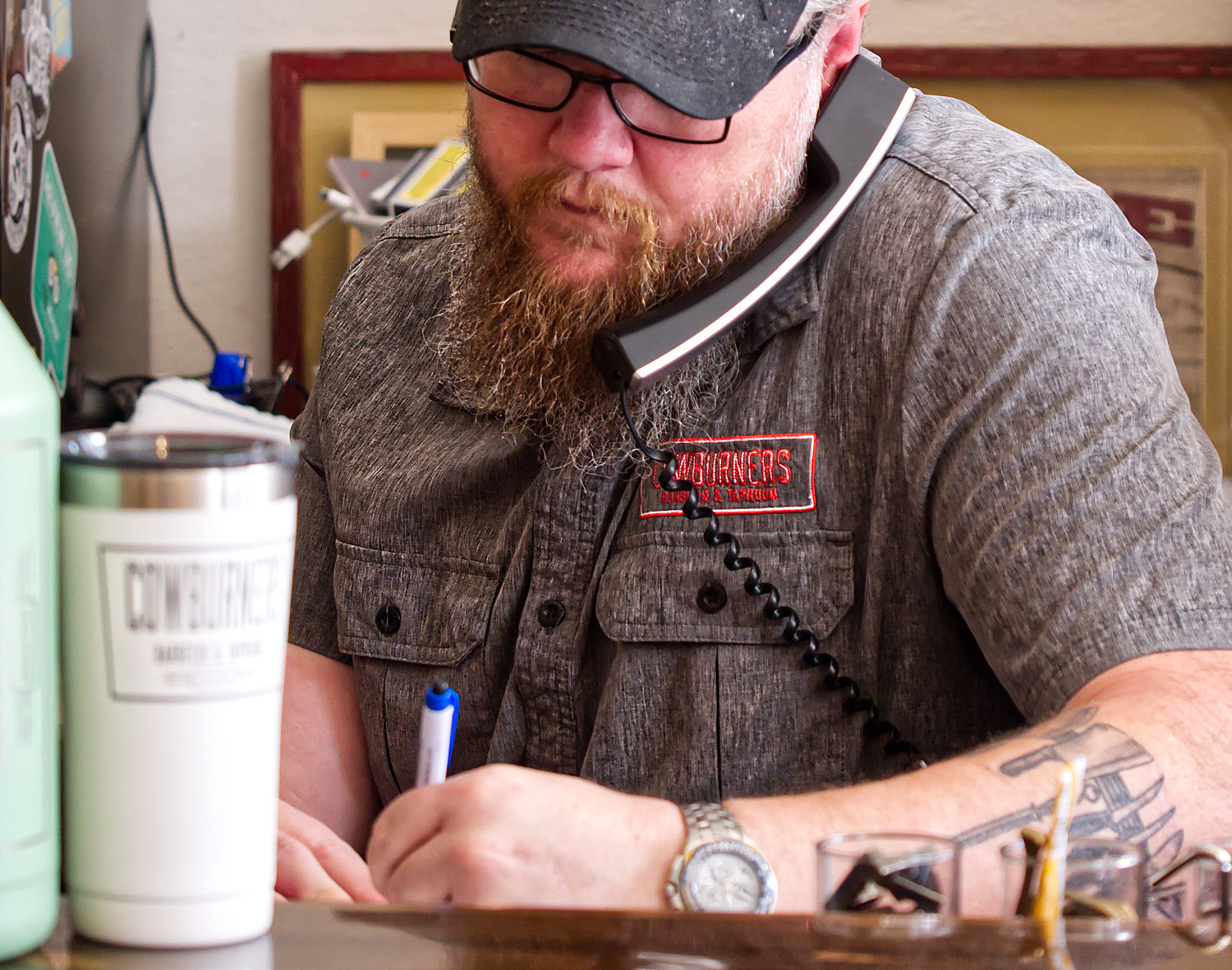 Jason Herring, owner of Cowburners BBQ and Taproom in downtown Mineola, takes a call-in order at the restaurant, which has remained open for takeout service during the coronavirus restrictions which have been ongoing for more than a month. The governor announced restaurants can reopen on Friday while following social distancing and capacity requirements.